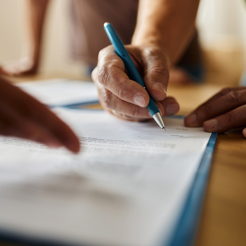 close up of someone signing document