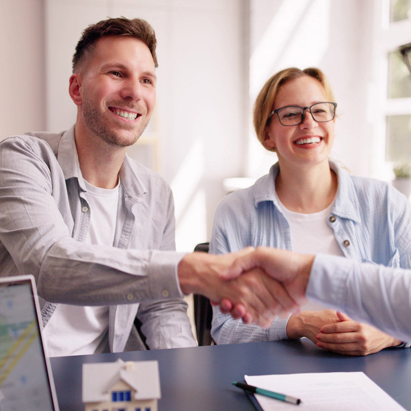 two people shaking hands during meeting